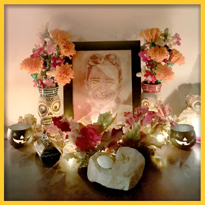 Photo of an alter with a drawing of Nicolasa Chávez's sister, surrounded by flowers, candles, and Halloween-themed trinkets