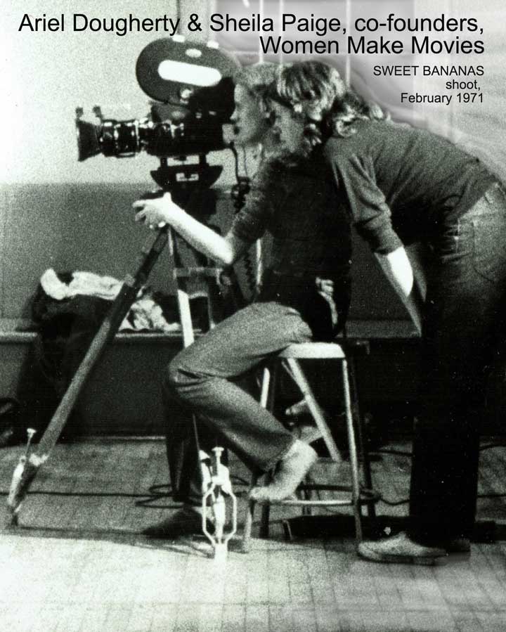 Black and white photo of two women behind a movie camera. Text reads: "Ariel Dougherty & Sheila Paige, co-founders, Women Make Movies. SWEET BANANAS shoot, February 1971