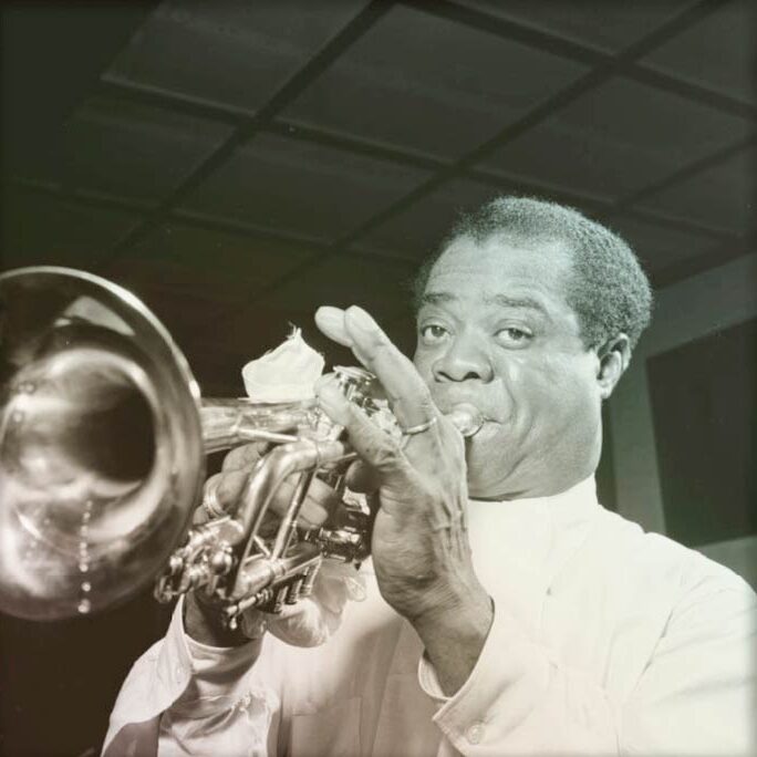 Photo of Louis Armstrong playing trumpet