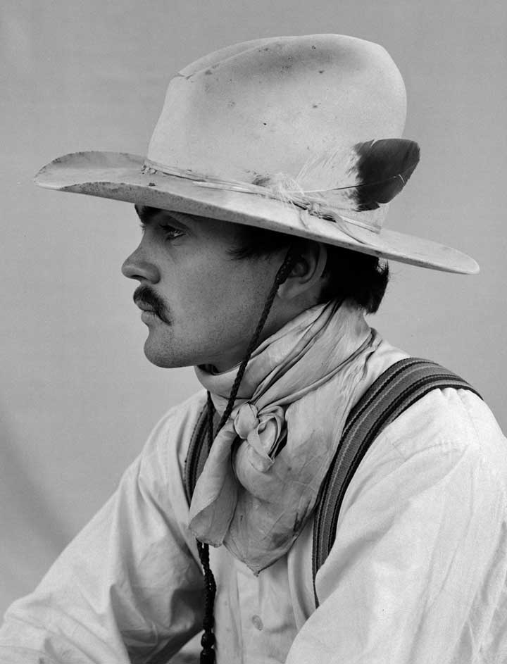 Black and white portrait of a cowboy in profile