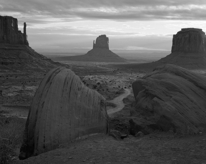 A black and white landscape photo of Monument Valley.
