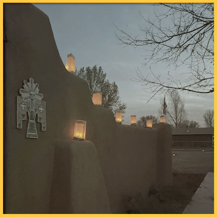 Luminarias light up adobe wall in New Mexico. Credit: Photo Courtesy Leeanna Torres.