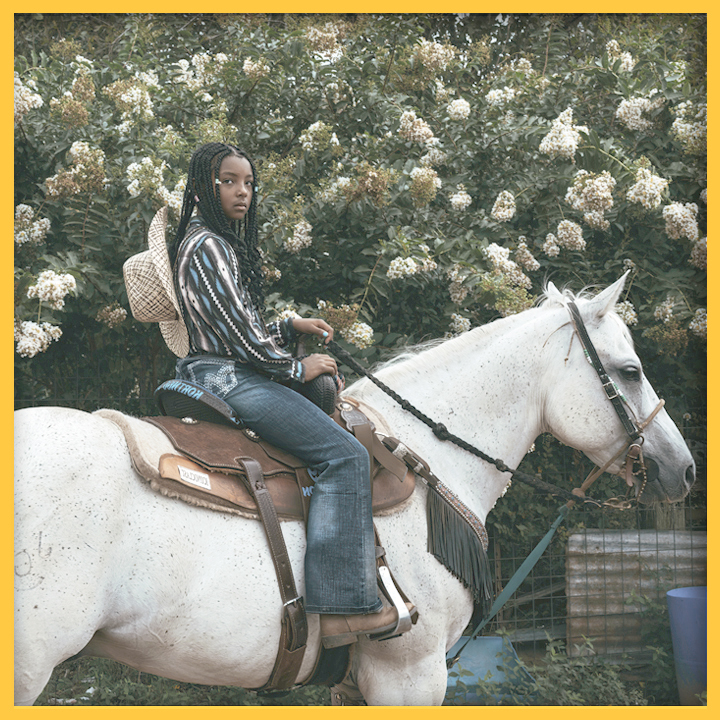 young African American teenage cowboy on his horse