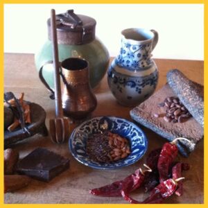 A photo still life of various chocolate making implements and ingredients