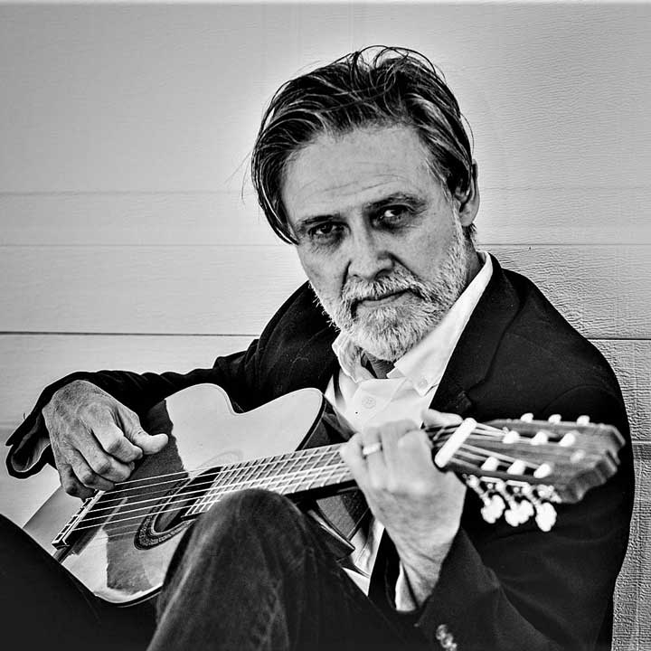 Black and white photo of Rob Martinez playing his guitar