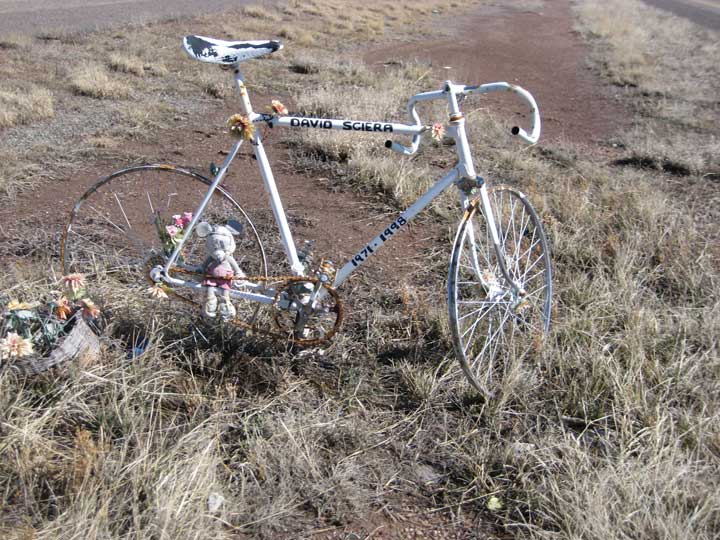 Photo of a ghost bike memorial, reads "David Sciera 1971-1998"