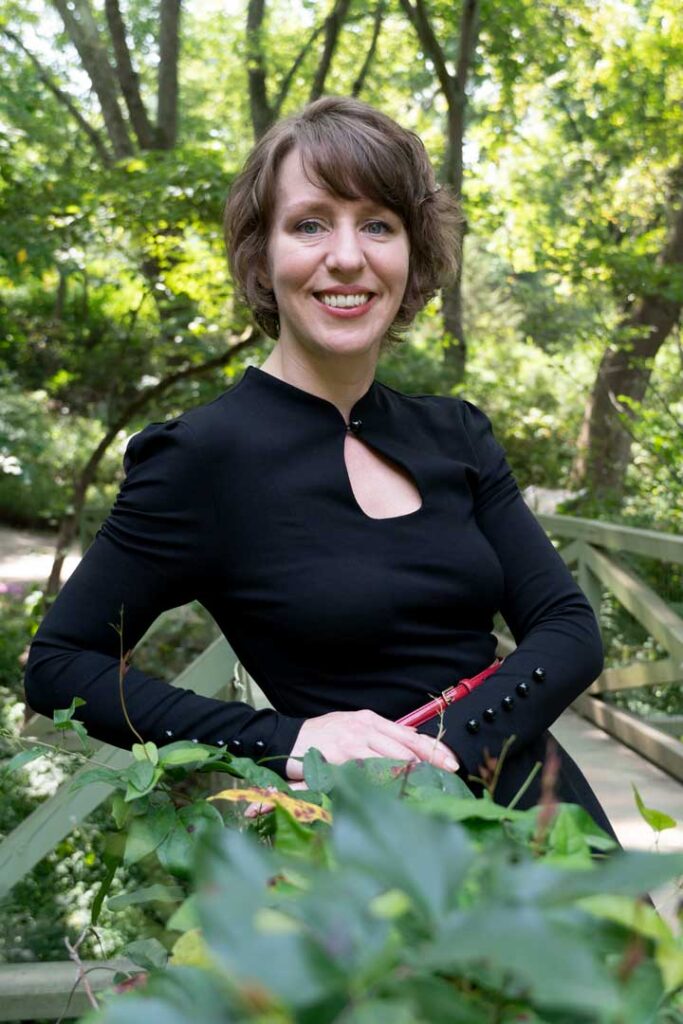 Photograph of blog contributor, Liz Hamilton outside in front of trees