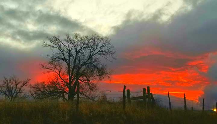 Photo of a bright red sunset in Estancia New Mexico.