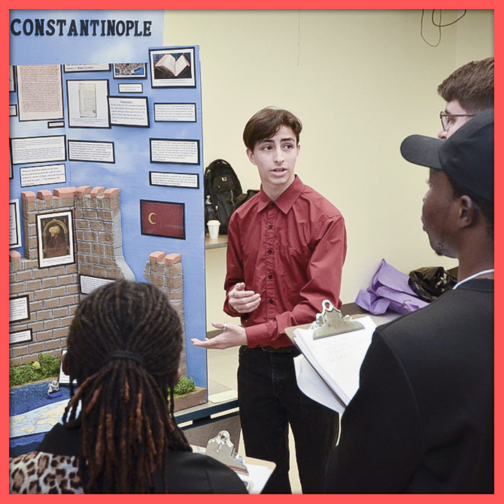 Student presenting to judges in front of an exhibit board about Constantinople