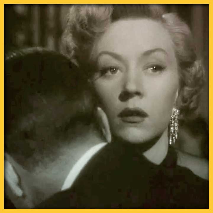 Image of Dorothy B. Hughes from the movie "In a Lonely Place," looking over a man's shoulder