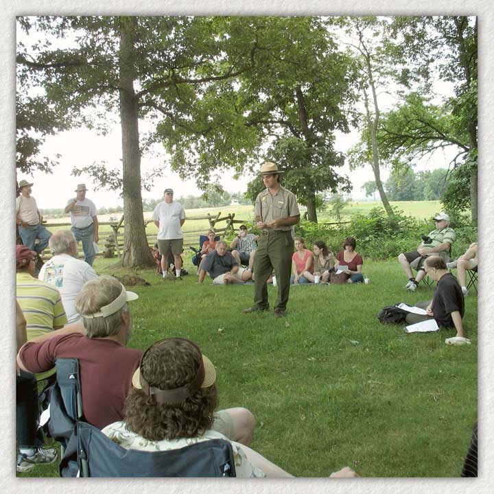 Raffi Andonian dressed as a park ranger giving a presentation outdoors