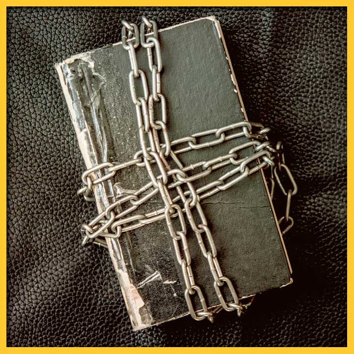 Photo of a black book wrapped in chains