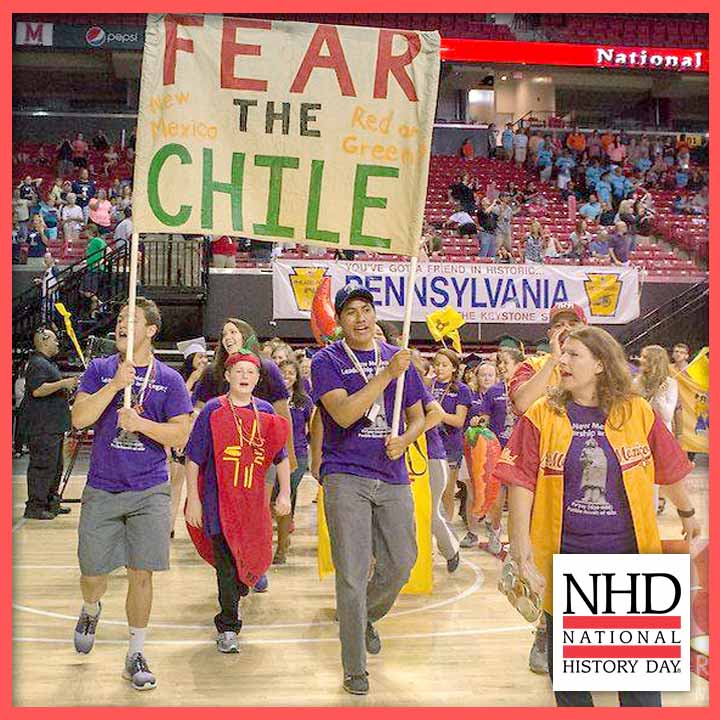 Students marching with a sign that reads "FEAR THE CHILE" at the NHD national contest opening ceremony