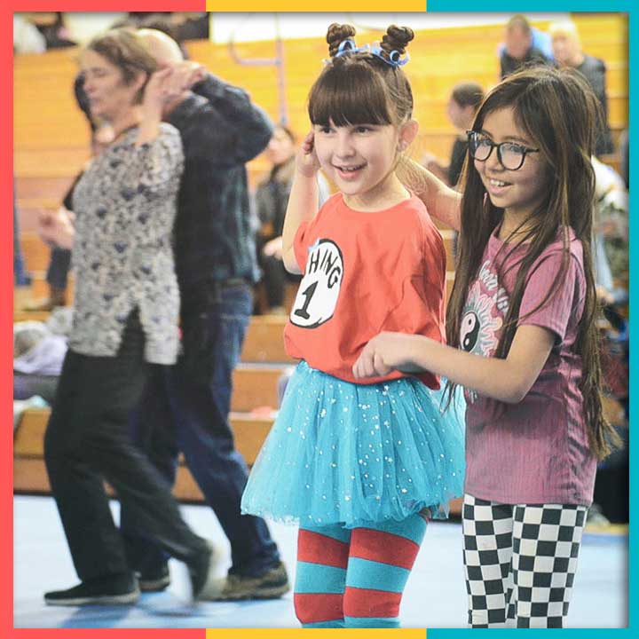 Two little girls smiling and dancing