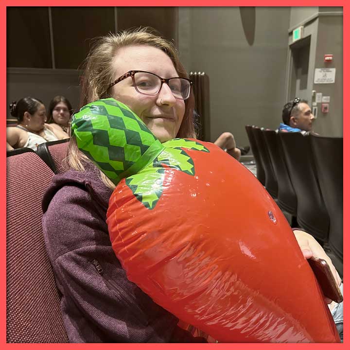 Photo of Kathryn McClenahan with an inflatable red chile