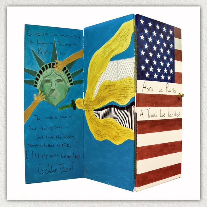 "Abra La Puerta A Todas Las Familias" by Michael Pratt. An art piece painted on doors featuring the Statue of Liberty, her torch, the US flag, and Spanish and English text