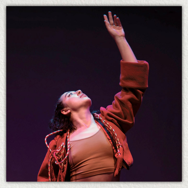 Photo of woman reaching up during a dance performance