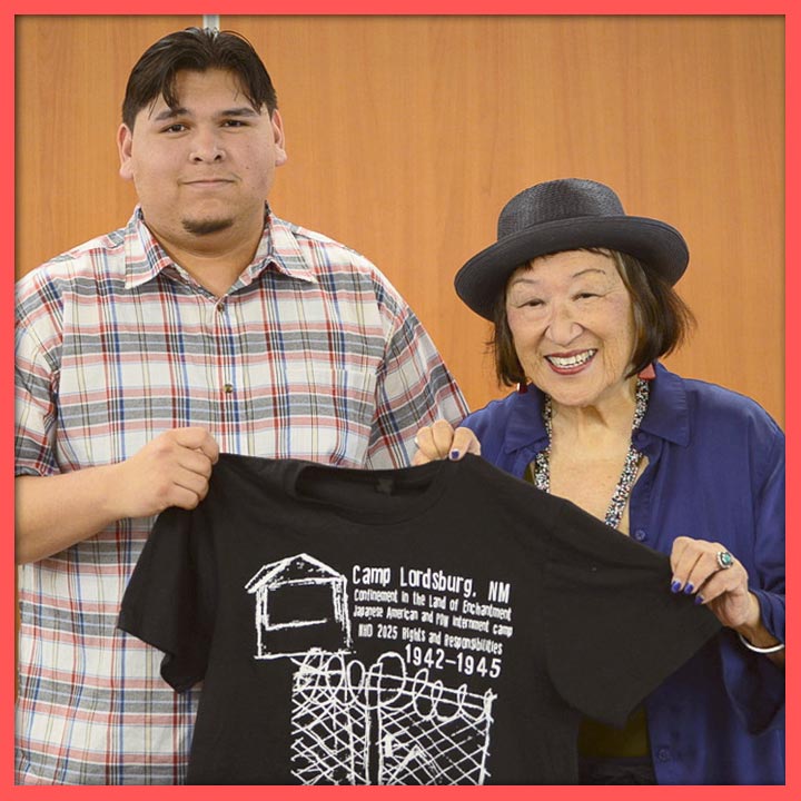 Photo of Isaac Duarte and Nikki Nojima Louis holding up Isaac's winning t-shirt design