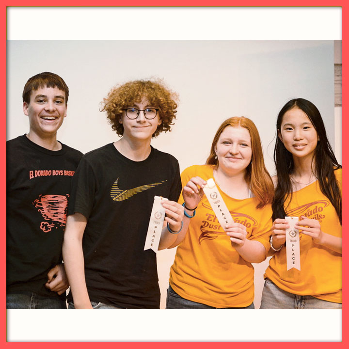 Four students showing off their NHD ribbons