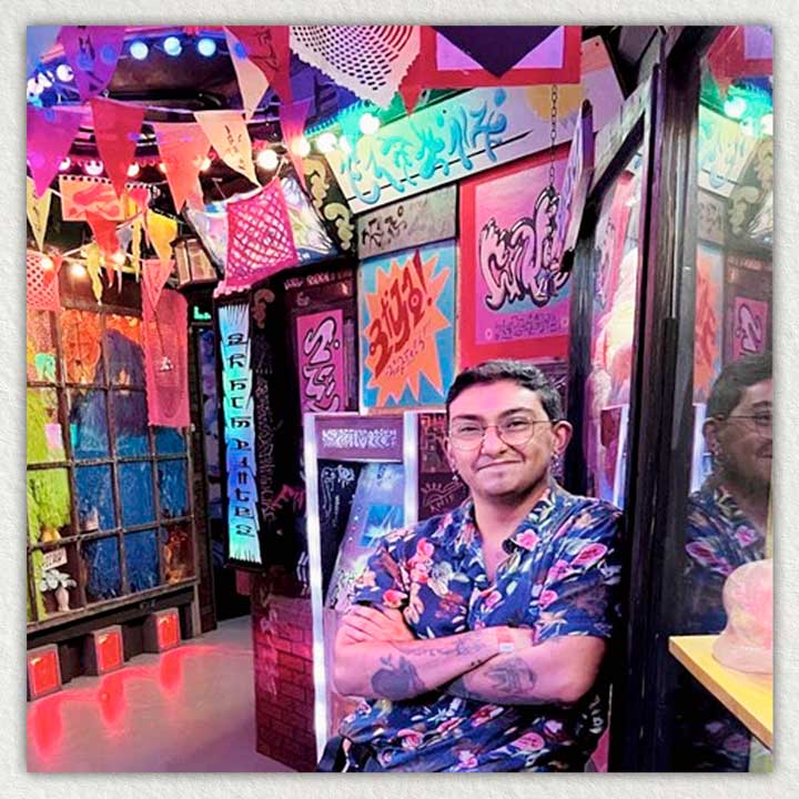Photo of Victoriano Cardenas posing in a Meow Wolf art exhibit