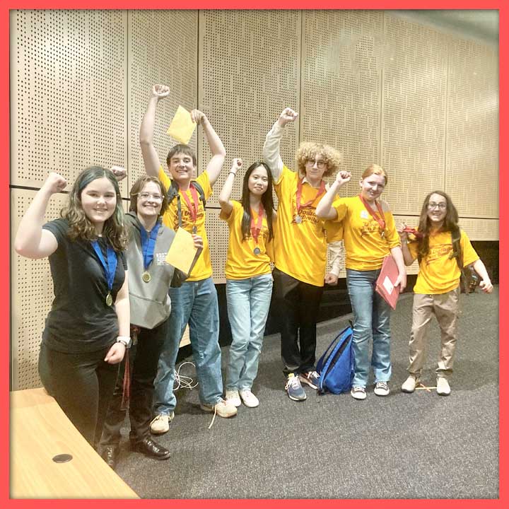 Seven students celebrating their NHD wins, showing off their certificates/medals