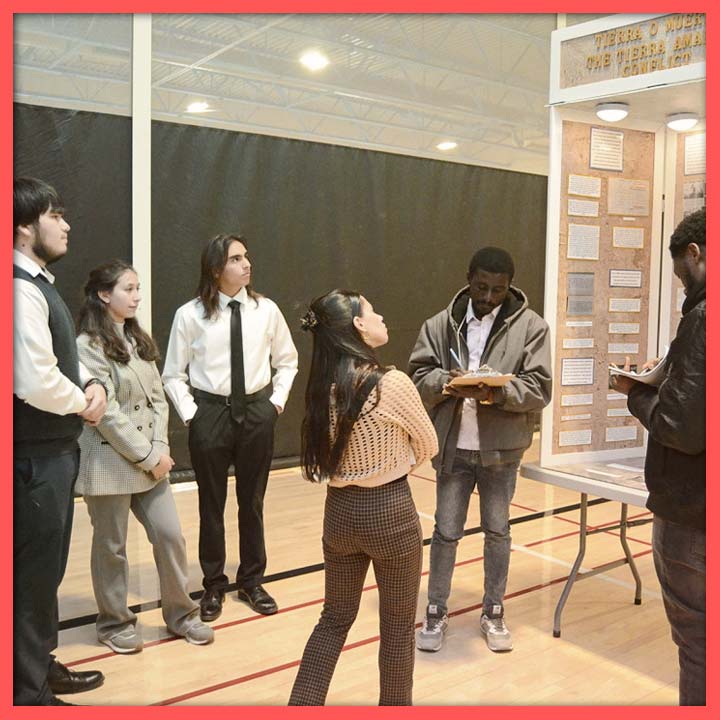 Three students presenting their exhibit to three NHD judges