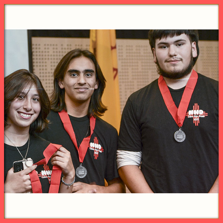 Three students showing off their NHD medals