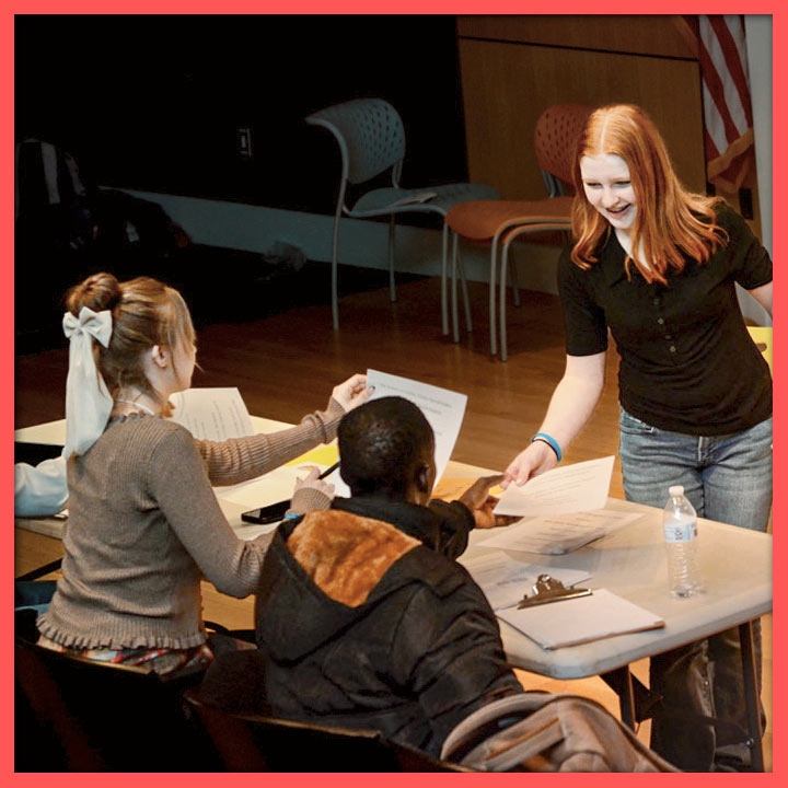 A student presenting papers to NHD judges